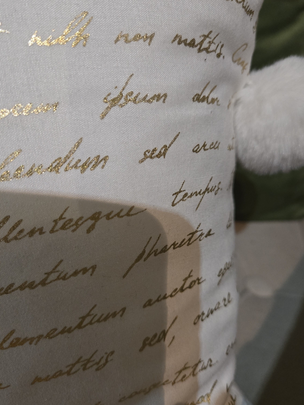 White Pillow with Gold Script Accent